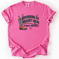 Rounding Up Bright Ideas First Grade Tee in Crunchberry